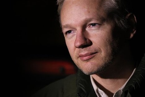 The founder of WikiLeaks Julian Assange speaks to members of the media as he leaves a police station in Beccles, England, after complying with bail his conditions, Friday, Dec. 24, 2010.