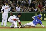 Team Korea first baseman Kim Tae-kyun, right, is tagged out by Team Japan shortstop Hiroyuki Nakajima at third base during a pickoff play as third baseman Shuichi Murata (25) looks on in the fourth inning of their World Baseball Classic game at Tokyo Dome in Tokyo Monday, March 9, 2009.