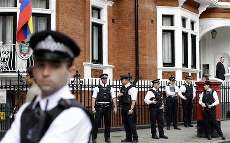 British police officers stand guard outside the Ecuadorian Embassy, where WikiLeaks founder Julian Assange is believed to be taking refuge, in London, Thursday, Aug. 16, 2012.