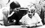 File - Survivor Juliane Koepcke, right, writes a note to friends following her return to Lima, Peru, March 19, 1972, after recovering from injuries received in a Christmas Eve plane crash.