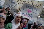 In this photo taken on Wednesday Dec. 21, 2011, anti-Syrian regime protesters shout slogans during a demonstration in the Baba Amr area, in Homs province, Syria. Arab League monitors kicked off their one month mission in Syria with a visit on Tuesday, Dec. 27, 2011 to Homs, the first time Syria has allowed outside monitors to the city at the heart of the anti-government uprising. Several from the team of 12 stayed in the city overnight, and the team continued to work in Homs on Wednesday. The mo