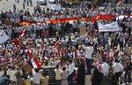 In this photo released by the Syrian official news agency SANA, Syrian pro-government protesters carry national flags and banners as they call for a reform program and in support of the national unity in the city of Sanamein, in the southern city of Daraa, Syria, Wednesday, July 13, 2011.