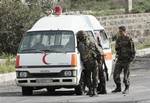 Syrian soldiers check an ambulance , that according to the official Syrian television was attacked and a doctor and two paramedics killed, in the southern city of Daraa, Syria, Wednesday March 23, 2011. Syrian security forces shot live ammunition and tear gas early Wednesday near a mosque where protesters have been camped out in southern Syria, killing six people including a paramedic, activists said. The early morning attack near the al-Omari mosque in the southern city of Daraa marks the deadl