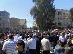 In this citizen journalism image acquired by the AP, people attend an anti-government protest in Daraa, Syria, Friday, April 15, 2011. Tens of thousands of people chanting 