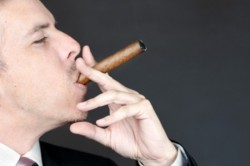 A CEO, enjoying his cigar after trickling down on us