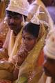 Brides and grooms sit during a mass marriage ceremony on 123 Couples who will be tying the knot out on 1st July 2012 at Haldiram Banquets organisational by Vishwa Jagriti Mission Trust in Kolkata on Sunday 1st July 2012