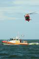 NEW ORLEANS A Coast Guard MH-65C Dolphin helicopter crew from Air Station New Orleans lowers a rescue basket to the crew of a 45-foot Response Boat Medium on Lake Pontchartrain as part of a training evolution, Jan. 17, 2012. The crewmembers train to sharpen the skills and gain experience needed to provide a fast response and efficient resolution to maritime emergencies. U.S. Coast Guard photo by Petty Officer 3rd Class Stephen Lehmann. (1500465) ( Coast Guard units train on Lake Pontchartrain )