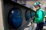 Interior Communications Electrician 3rd Class Bethany Palenik, from St. Louis, disassembles an improved fresnal lens optical landing system aboard the aircraft carrier USS Ronald Reagan (CVN 76)