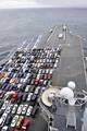 The aircraft carrier USS Ronald Reagan (CVN 76) transports Sailors' vehicles while transiting the Pacific coast to Naval Base Kitsap.