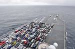 The aircraft carrier USS Ronald Reagan (CVN 76) transports Sailors' vehicles while transiting the Pacific coast to Naval Base Kitsap.