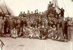 Arturo Toscanini (standing in the center, sporting a bow tie and cap) with the orchestra aboard the S.S de Grasse, embarking on their European tour, 1930.. New York Philharmonic Archives