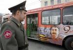 Russian servicemen look at a bus decorated to mark the upcoming Victory Day celebrations, with a portrait of Soviet dictator Josef Stalin, in St. Petersburg, Russia, Wednesday, May 5, 2010.