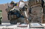 First Lt. Geoffrey Dean, a platoon leader with the 82nd Airborne Division’s 1st Brigade Combat Team, photographs evidence collected during the search of a building for homemade explosives May 4, 2012, Ghazni Province, Afghanistan. Every infantry company has soldiers trained in the gathering of evidence. (U.S. Army photo by Sgt. Michael J. MacLeod)