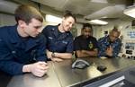 Sailors talk to New Orleans Saints tight-end Jimmy Graham during a holiday morale phone call aboard the Nimitz-Class aircraft carrier USS Abraham Lincoln (CVN 72).