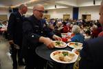 JUNEAU, Alaska - Chief Petty Officer Zachary Graham prepares to serve a guest during the 38th Annual Senior Citizens Holiday Dinner at the Elizabeth Peratrovich Hall Dec. 11, 2011. The event, sponsored by the Coast Guard Chief Petty Officers Association, provided free food and entertainment for hundreds of local residents. U.S. Coast Guard photo by Petty Officer 3rd Class Grant DeVuyst. (1477924) ( )