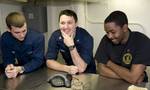 Sailors talk to New Orleans Saints tight-end Jimmy Graham during a holiday morale phone call aboard the Nimitz-Class aircraft carrier USS Abraham Lincoln (CVN 72).