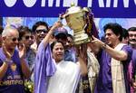 Chief Minister of West Bengal, Mamata Banerjee (front-L), along with Shah Rukh Khan, owner of IPL cricket team Kolkata Knight Riders (CL), captain of Kolkata Knight Riders, Gautam Gamvir (CR) and actress Juhi Chawla (front-R) hold up the IPL Twenty20 champion's trophy during celebrations in front of the Writers Building in Kolkata on May 29, 2012.