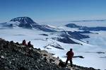 Three members of a dinosaur expedition led by Illinois paleontologist Dr. William Hammer, from Augustana College in Rock Island, Ill., look out across the summer landscape last month from the dig site at 13,000 feet on Mount Kirkpatrick, about 400 miles from the South Pole. The expedition, bundled in fleece and hacking away with drills, jackhammers and dynamite, found pieces of rock-encased fossils which they believe might match the first dinosaur fossil ever found onAntarctica's mainland, disco