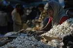 A woman sorts garlic at a wholesale market in Gauhati, India, Friday, Dec. 31, 2010. According to new reports, a rise in vegetable prices, especially onion, pushed India's food inflation to a 10-week high in the week ended Dec. 18.