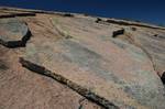 Granite dome exfoliation (or onion skin weathering) is the gradual removing of spall due to the cyclic increase and decrease in the temperature of the surface layers of the rock.