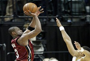 Miami Heat's Dwyane Wade, left, puts up a shot at the buzzer over Indiana Pacers' Brandon Rush, right, at the end of an NBA basketball game in Indianapolis, Wednesday, March 25, 2009. Wade's shot missed and Indiana won 90-88. (AP Photo/Tom Strattman)