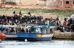 Would-be migrants believed to be from Tunisia are seen on the shores of the Sicilian island of Lampedusa, Italy, Friday, Feb. 11, 2011 after arriving there by boat. Some 1,000 Tunisians have fled the chaos in their homeland and arrived by boat on a tiny Italian island, prompting Italy to demand Friday that the European Union take stronger action to prevent an uncontrolled wave of migrants from North Africa. Since Jan. 16, about 1,600 Tunisians have landed in Italy, the U.N. refugee agency says,