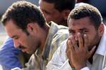 Some of the 241 would be immigrants coming from North Africa and arrived by boat sit in the harbour of the Italian southern island of Lampedusa, off the Sicilian coast, Sunday, Aug. 29, 2