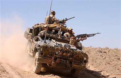 In this photo released by the Australian Defense Department, an Australian Surveillance Reconnaissance Vehicle (SRV) patrols outside the perimeter of a forward operating base in Afghanistan Sept. 17, 2005. An elite Australian commando was injured and an Afghani soldier killed when their patrol clashed with insurgents in Afghanistan, Friday, Sept. 23, 2005. The clash came less than a month after a group of 190 Australian special forces commandos began arriving in Afghanistan to bolster international efforts to restore law and order amid an upsurge in violence blamed on the al-Qaida terror network and supporters of the ousted Taliban regi