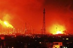 Fire rises over Amuay refinery near Punto Fijo, Venezuela, Saturday, Aug. 25, 2012. A huge explosion rocked Venezuela's biggest oil refinery, killing at least 19 people and injuring dozens, an official said.