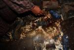 A man points to the blood stains at the house of Mohammad Maqbool Bhat on Monday, February 14, 2011, who lost his three children in an explosion last night. The blast occurred in Maloora, some 15 kilometres from Srinagar when Maqbool�s 15-year-old son Noor Mohammed was fiddling with an explosive device when it went off with a bang.