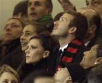 British soccer ace David Beckham and his wife Victoria look at he match at the San Siro stadium of Milan, Italy, during an Italian first division soccer match between AC Milan and Udinese Sunday, Dec. 21, 2008. David Beckham's arrival at AC Milan was greeted with great fanfare and a modicum of skepticism over whether the 33-year-old midfielder will be able to contribute to his new team's star-filled lineup. Beckham acknowledged during an introductory press conference Saturday that playing for Mi