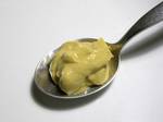 Dijon mustard on a spoon.