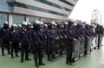 Thai riot policemen stand guard outside the Constitution Court during a ruling Friday, July 13, 2012 in Bangkok, Thailand.