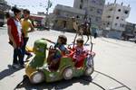 Palestinian Children visit a luna park in the Rafah refugee camp, during the Eid el-Fitr holiday in the southern Gaza Strip on August 20, 2012. Eid al-Fitr day is a holiday for Muslims which marks the end of Ramadan, the Islamic holy month of fasting.Photo by Ahmed Deeb / WN