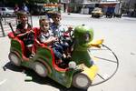 Palestinian Children visit a luna park in the Rafah refugee camp, during the Eid el-Fitr holiday in the southern Gaza Strip on August 20, 2012. Eid al-Fitr day is a holiday for Muslims which marks the end of Ramadan, the Islamic holy month of fasting.Photo by Ahmed Deeb / WN