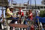 Palestinian Children visit a luna park in the Rafah refugee camp, during the Eid el-Fitr holiday in the southern Gaza Strip on August 20, 2012. Eid al-Fitr day is a holiday for Muslims which marks the end of Ramadan, the Islamic holy month of fasting.Photo by Ahmed Deeb / WN