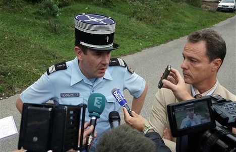 Gendarmerie Col. François, left, and Annecy prosecutor Eric Maillaud answer reporter near a killing site, near Chevaline, French Alps, Wednesday Sept. 5, 2012.