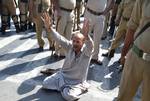 Jammu and Kashmir state lawmaker Engineer Abdul Rasheed scuffles with Indian policeman during a protest outside the state legislature house in Srinagar on September 29, 2011. Rasheed, was protesting against the stalling of a clemency request he moved in the house on September 28 for Afzal Guru, a man sentenced to death in a deadly 2001 attack on India's Parliament.