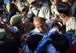 Jammu and Kashmir state lawmaker Engineer Abdul Rasheed scuffles with Indian policeman during a protest outside the state legislature house in Srinagar on September 29, 2011. Rasheed, was protesting against the stalling of a clemency request he moved in the house on September 28 for Afzal Guru, a man sentenced to death in a deadly 2001 attack on India's Parliament.