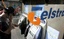 An unidentified man uses a Telstra pay phone in Sydney, Australia, Monday, Aug. 21, 2006.