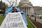 Occupy Olympia protester Dana Walker wears a sign that says 