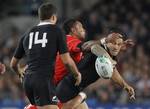 New Zealand's Sonny Bill Williams passes the ball to teammate Richard Kahui during their Rugby World Cup game against Tonga at Eden Park in Auckland, New Zealand, Friday, Sept. 9, 2011.