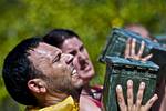 A participant in the Miami Superhero Scramble struggles to press an ammo can over his head during the Marine Mile section of the obstacle course March 24, 2012. The Superhero Scramble is 3.5 miles of wicked terrain with 18 or more obstacles including major water crossings. The race is designed to test the competitors’ resilience, strength and endurance. Marines from Recruiting Station Fort Lauderdale, Fla., brought a unique intensity to the event by putting participants to the test with a series