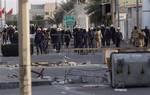 Bahraini riot police and soldiers move in on anti-government protesters Friday, March 25, 2011, in the western Shiite Muslim village of Malkiya, Bahrain, firing tear gas when villagers defied martial law by holding a protest march