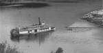 Sternwheeler Helen of the Adams Lake Lumber Company towing a log boom, Adams Lake, British Columbia