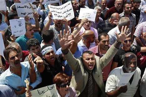 Palestinians demonstrate against the high cost of living in the West Bank city of Ramallah, Tuesday, Sept. 11, 2012. The prime minister pledged on Tuesday that the Palestinian Authority will decrease fuel prices and cut salaries of top officials, after days of protests in the West Bank.