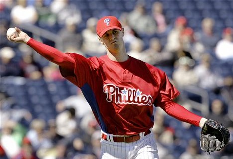 Philadlephia Phillies starting pitcher Kyle Kendrick throws to first base to keep Pittsburgh Pirates' Nyjer Morgan close to the base in the first inning of the baseball spring training game in Clearwater, Fla., Thursday, Feb. 28, 2008.