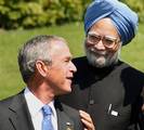 Prime Minister Manmohan Singh and US President George W. Bush share a light moment while posing for a photo at the G-8 Summit in Heiligendamm, Germany on Friday. PTI Photo by Atul Yadav *** Local Caption ***