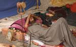 Indian Sadhu, or Hindu holy rest at a temporary camp at Babughat in Kolkata on 05 Jan 2012. Thousands of Hindu pilgrims taka holy dip at Gangasagar, hoping to wash away sins and others to secure a fine spouse, in a sun-worshipping tradition older than Hinduism itself in Eastern India City