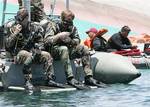 U.S. Navy and Philippine Coast Guard divers conduct search and rescue operation for the sunken passenger ferry, MV Princess of the Stars, off Sibuyan Island in central Philippines on Wednesday June 25, 2008. Philippine officials suspended Friday June 27, 2008 the search and retrieval of hundreds of bodies believed still trapped inside the sunken ferry following revelation that 22,000 pounds (10,000 kilograms) of toxic chemicals, Endosulfan, a pesticide intended for pineapple plantations of Del M